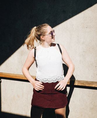 a woman standing in front of a wall