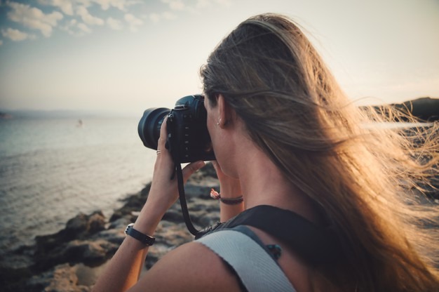 a woman taking photographs on a trip