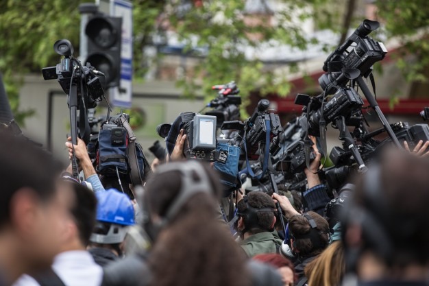 photojournalists in a herd for news capturing.