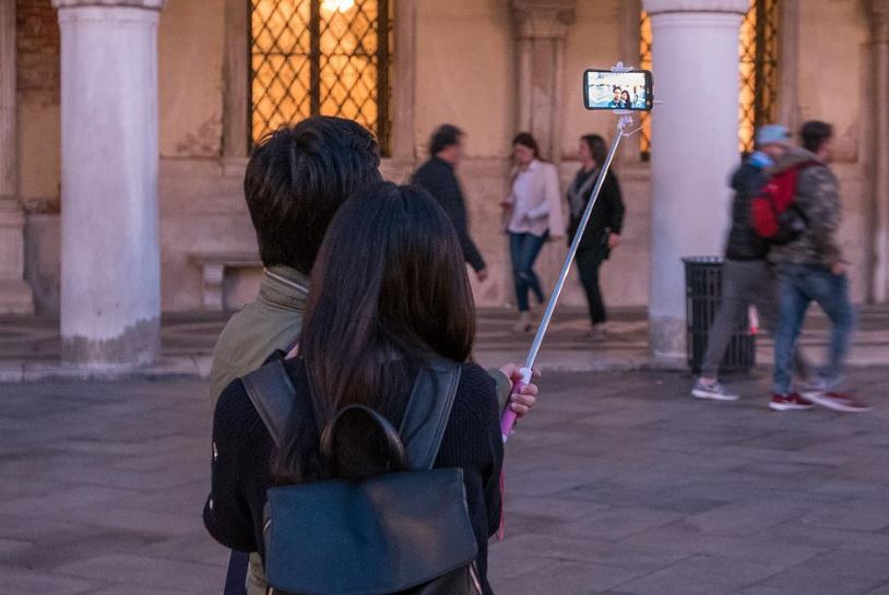tourists using a selfie stick