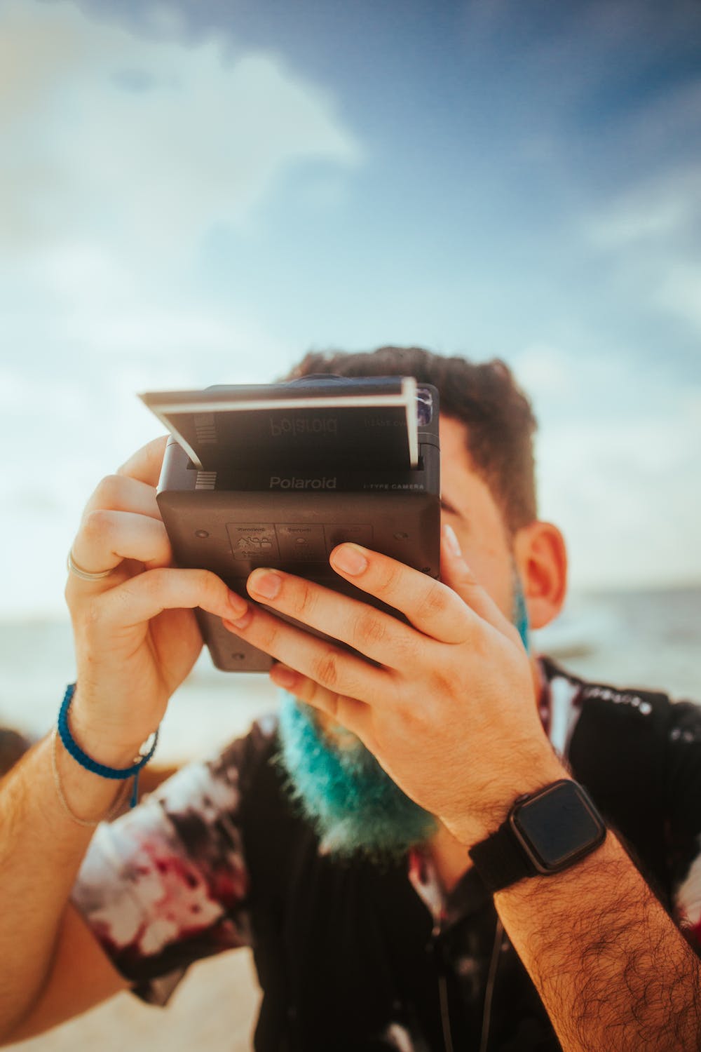 Man Taking Photo with Polaroid