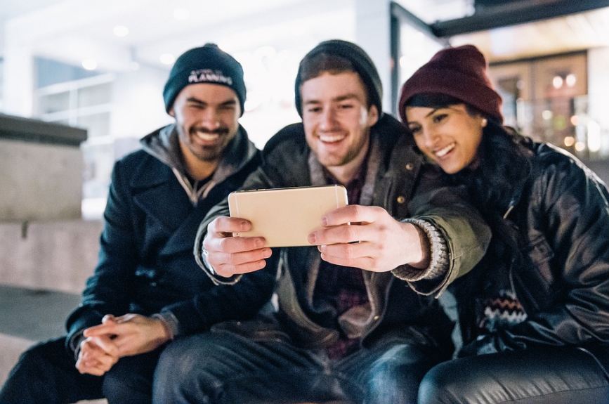 a group of three people clicking a selfie