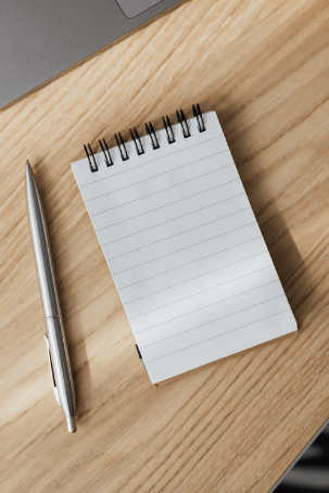 opened-notebook-and-silver-pen-on-desk