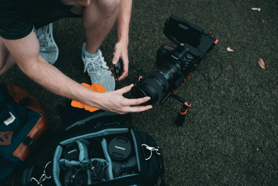 A man putting a lens filter on a camera