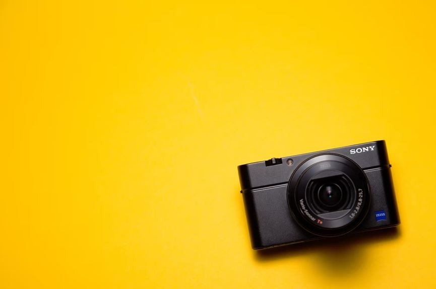Image of a Sony camera with a yellow background.