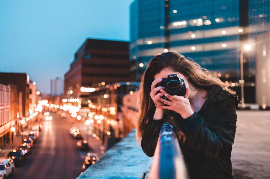 Picture of a girl taking a shot from her camera.