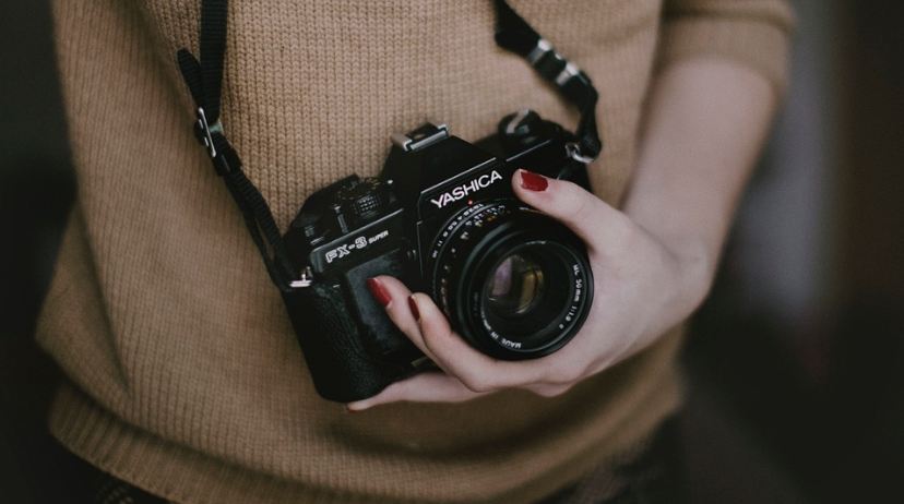 Picture of a woman holding a camera. 