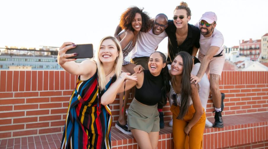 A group of men and women taking a selfie